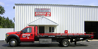 Sparta Towing & Recovery Building with flatbed in front.